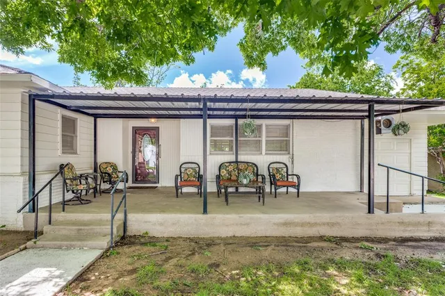 a front view of house with outdoor seating