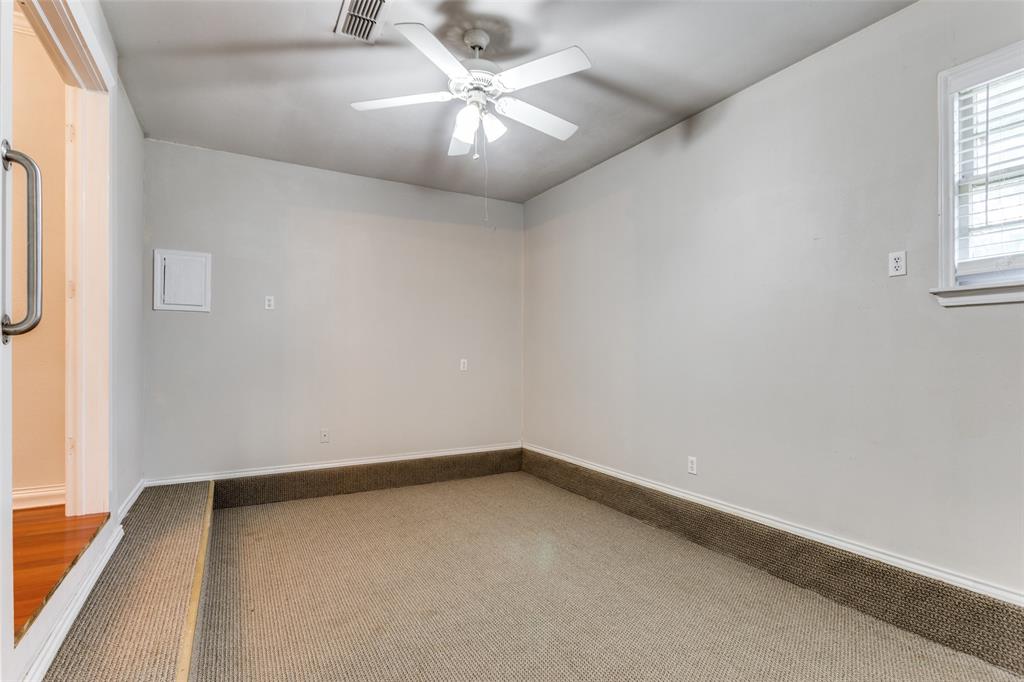 227 North 9th Street Jacksboro, TX 76458 - Photo 8 of 14 an empty room with windows and fan