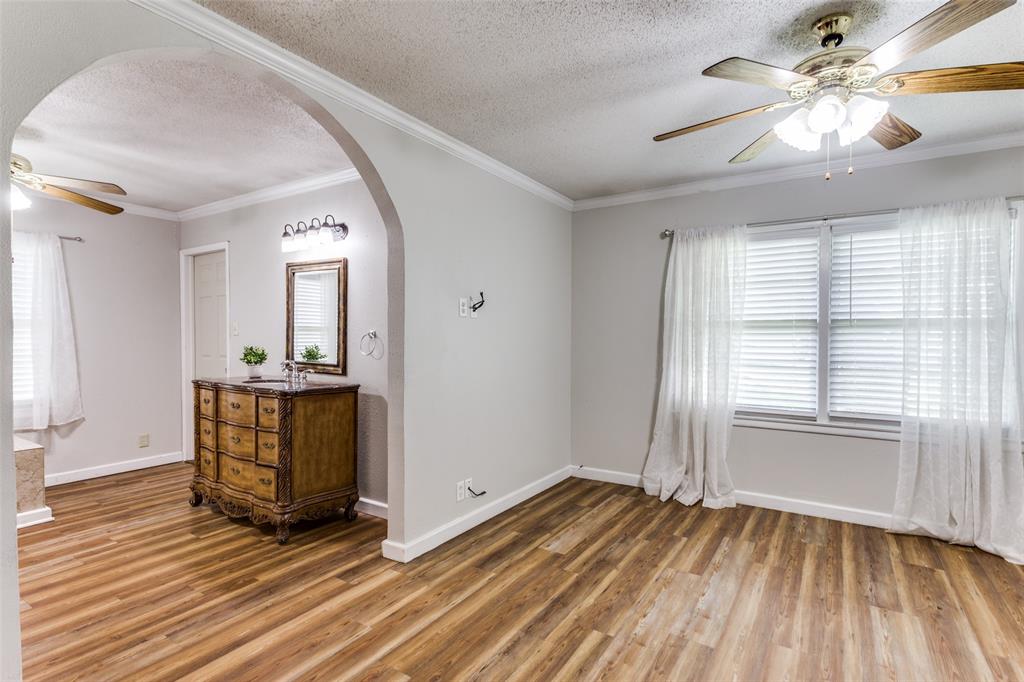 227 North 9th Street Jacksboro, TX 76458 - Photo 9 of 14 wooden floor in an empty room with a window
