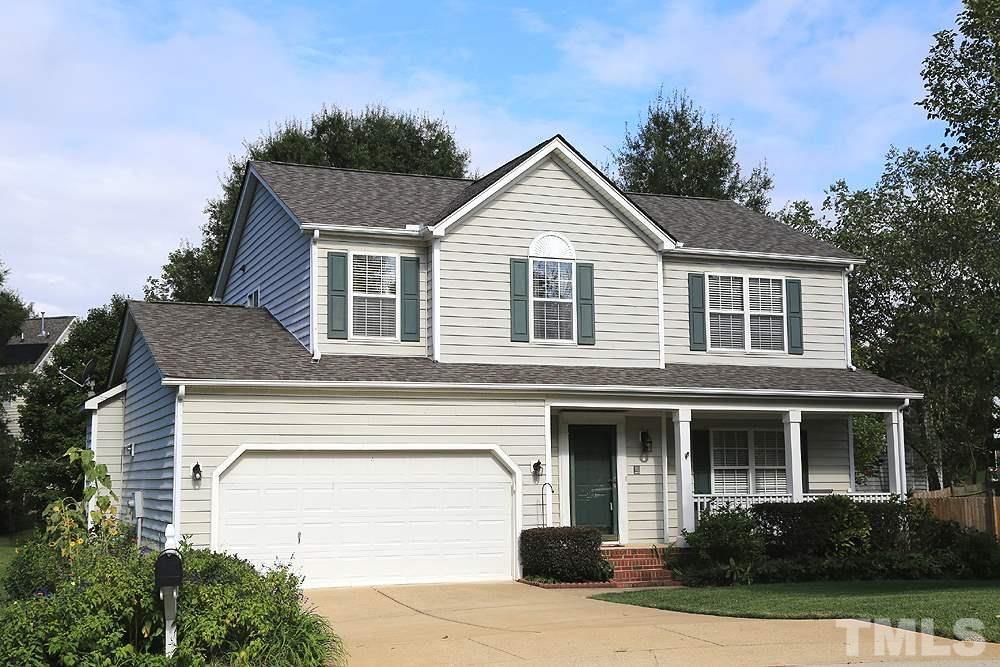 8313 Trumpetor Way Raleigh, NC 27613 - Photo 1 of 21 a front view of a house with a yard and garage