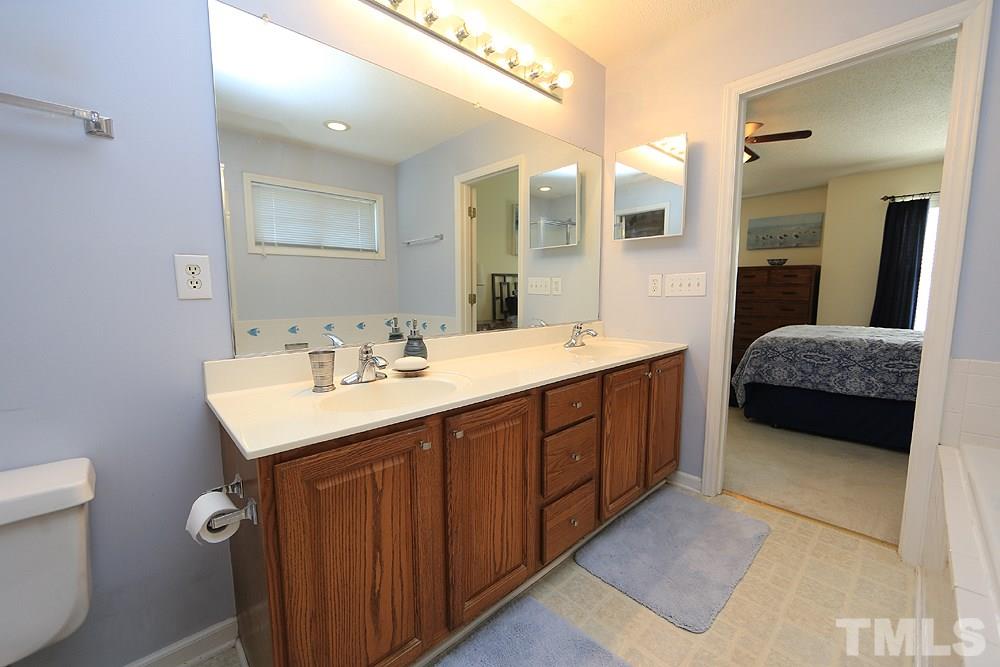 8313 Trumpetor Way Raleigh, NC 27613 - Photo 13 of 21 a en suite bathroom with a double vanity sink and a mirror