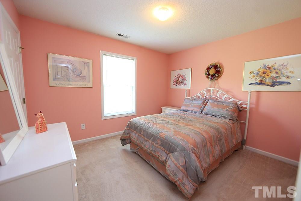 8313 Trumpetor Way Raleigh, NC 27613 - Photo 16 of 21 a bedroom with a bed and a window