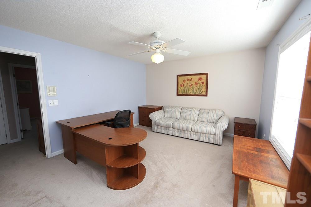 8313 Trumpetor Way Raleigh, NC 27613 - Photo 18 of 21 a living room with furniture and a window