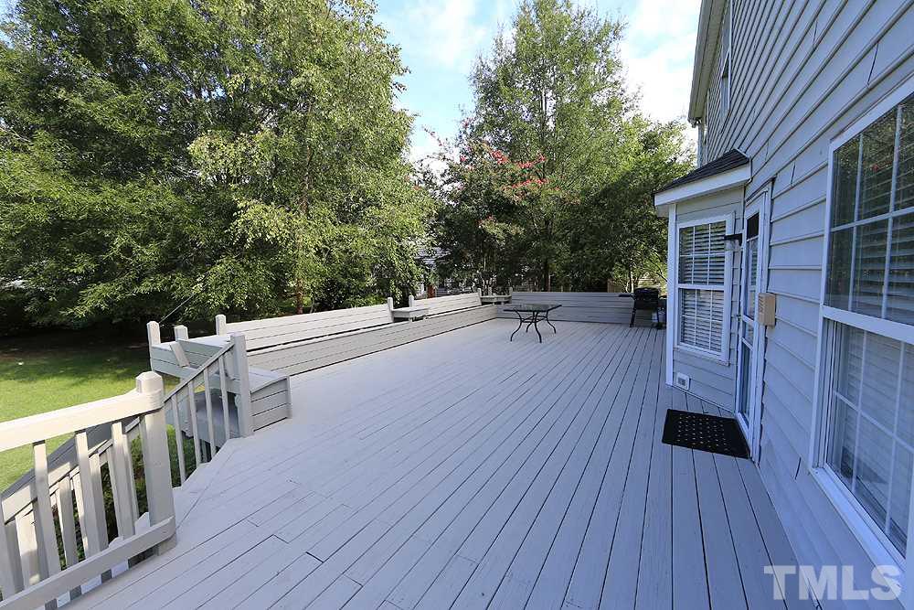 8313 Trumpetor Way Raleigh, NC 27613 - Photo 20 of 21 a view of a balcony with chairs and wooden floor