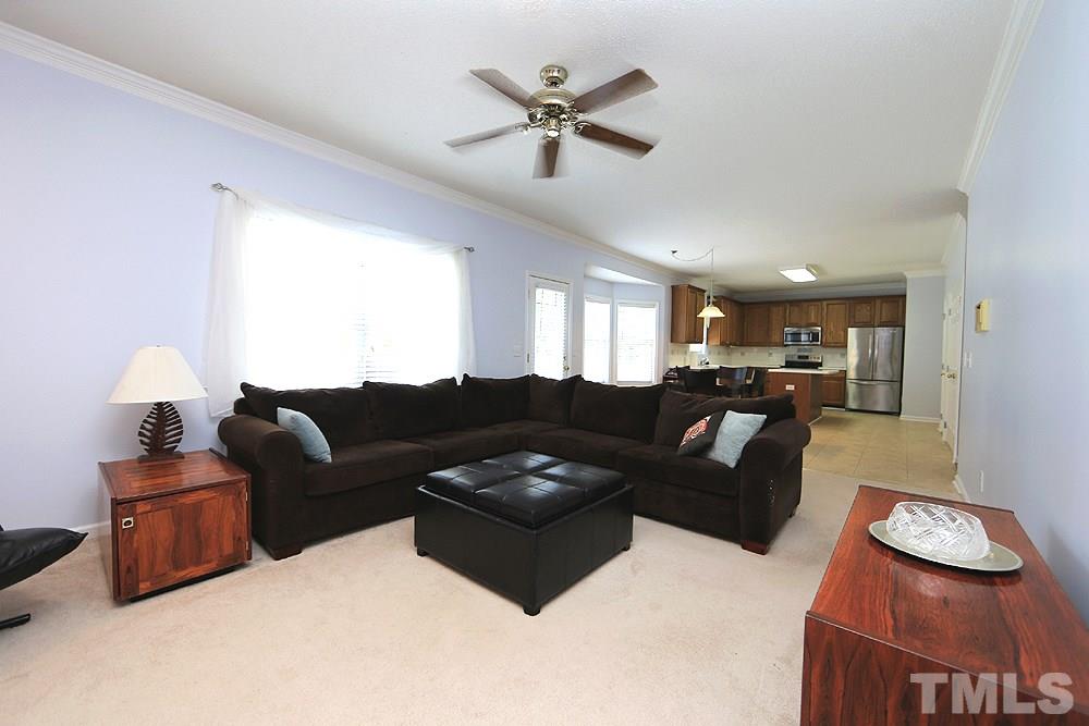 8313 Trumpetor Way Raleigh, NC 27613 - Photo 7 of 21 a living room with furniture and a ceiling fan