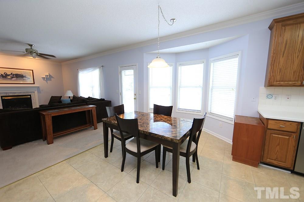 8313 Trumpetor Way Raleigh, NC 27613 - Photo 8 of 21 a view of a dining room with furniture and a window