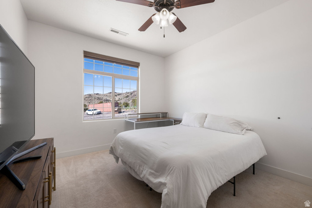 62 North Lucky 7 Road Veyo, UT 84782 - Photo 19 of 43 Bedroom with light carpet, ceiling fan, and a mountain view