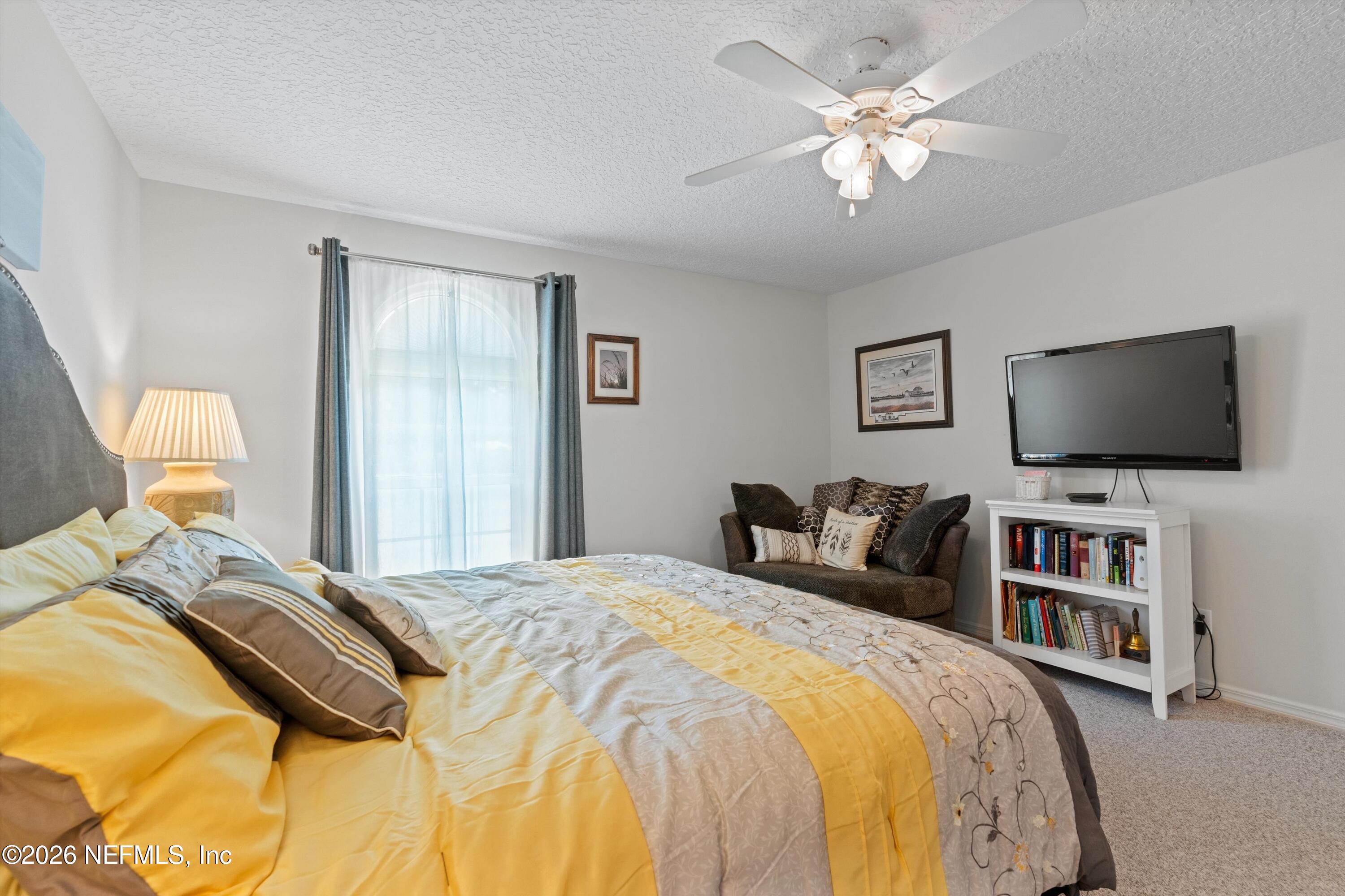 5566 Don Manuel Road Elkton, FL 32033 - Photo 24 of 47 a bedroom with a bed and a flat screen tv