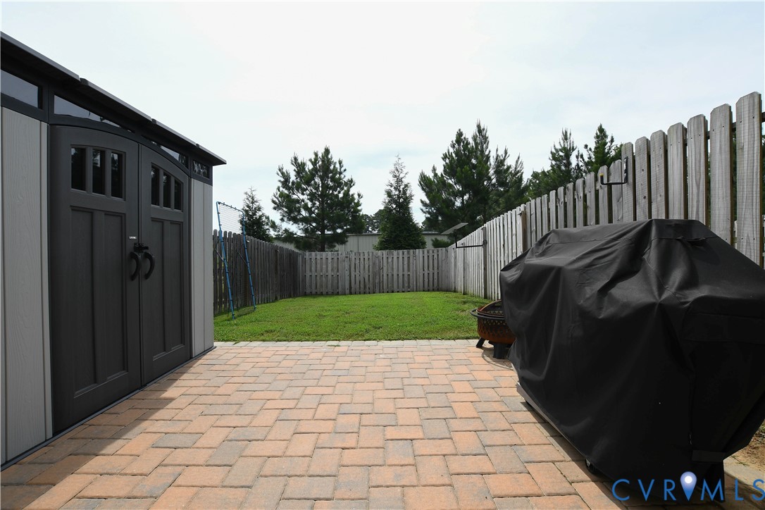1944 Kennington Park Road Aylett, VA 23009 - Photo 12 of 19 Expansive paver patio featuring a grey storage she