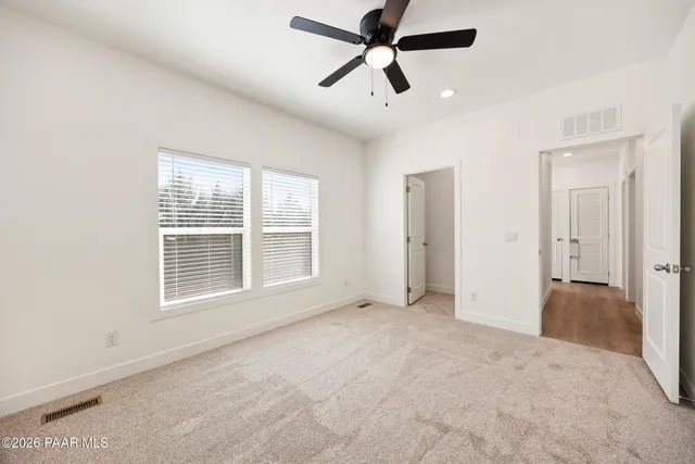 a view of a livingroom with a ceiling fan and window