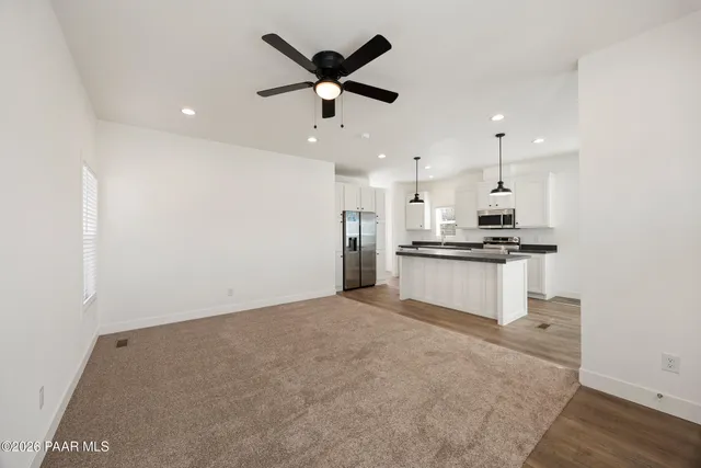 a view of kitchen with refrigerator sink and stove
