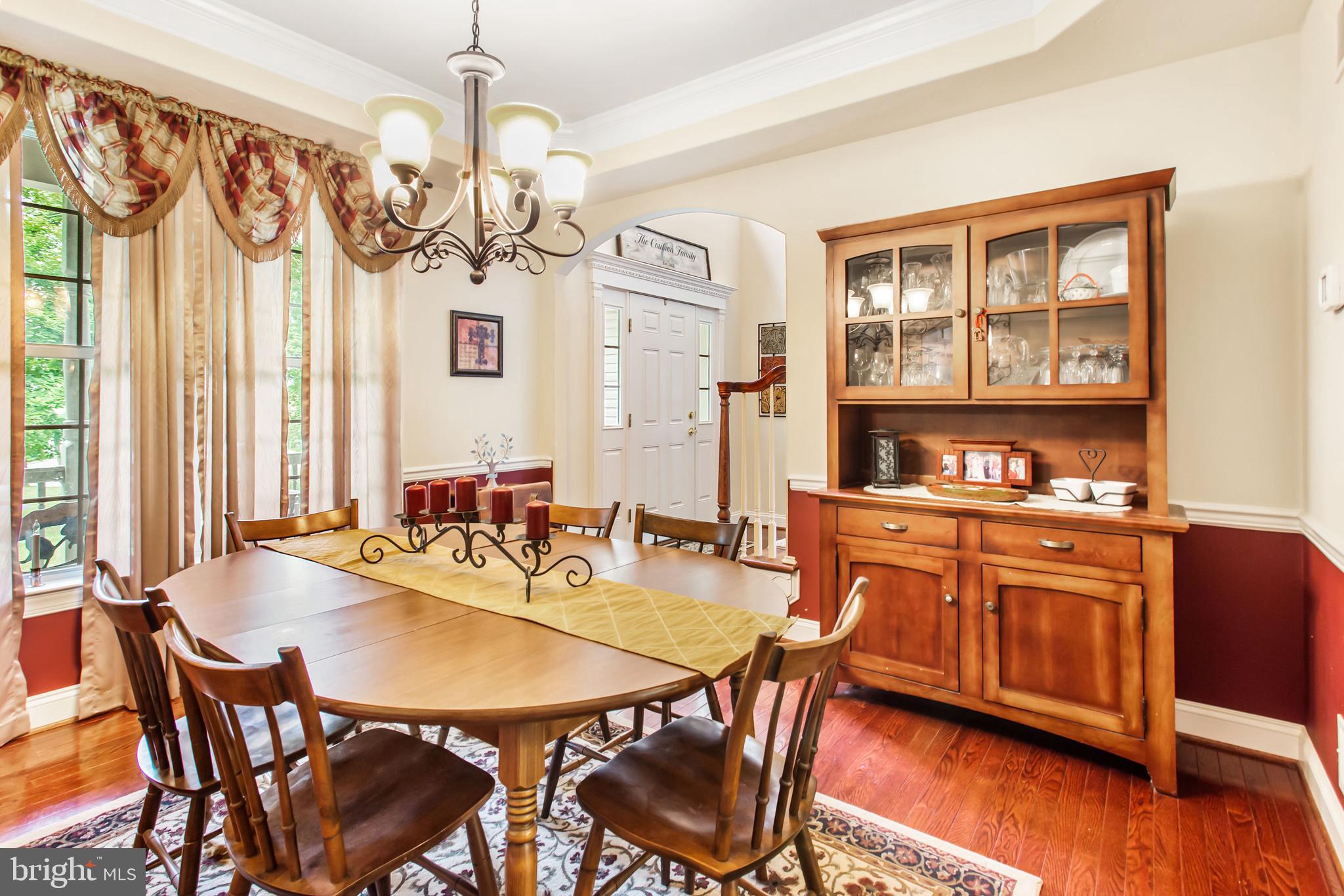 216 Blooming Grove Road Hanover, PA 17331 - Photo 15 of 60 a dining room with wooden floor a chandelier a wooden table and chairs