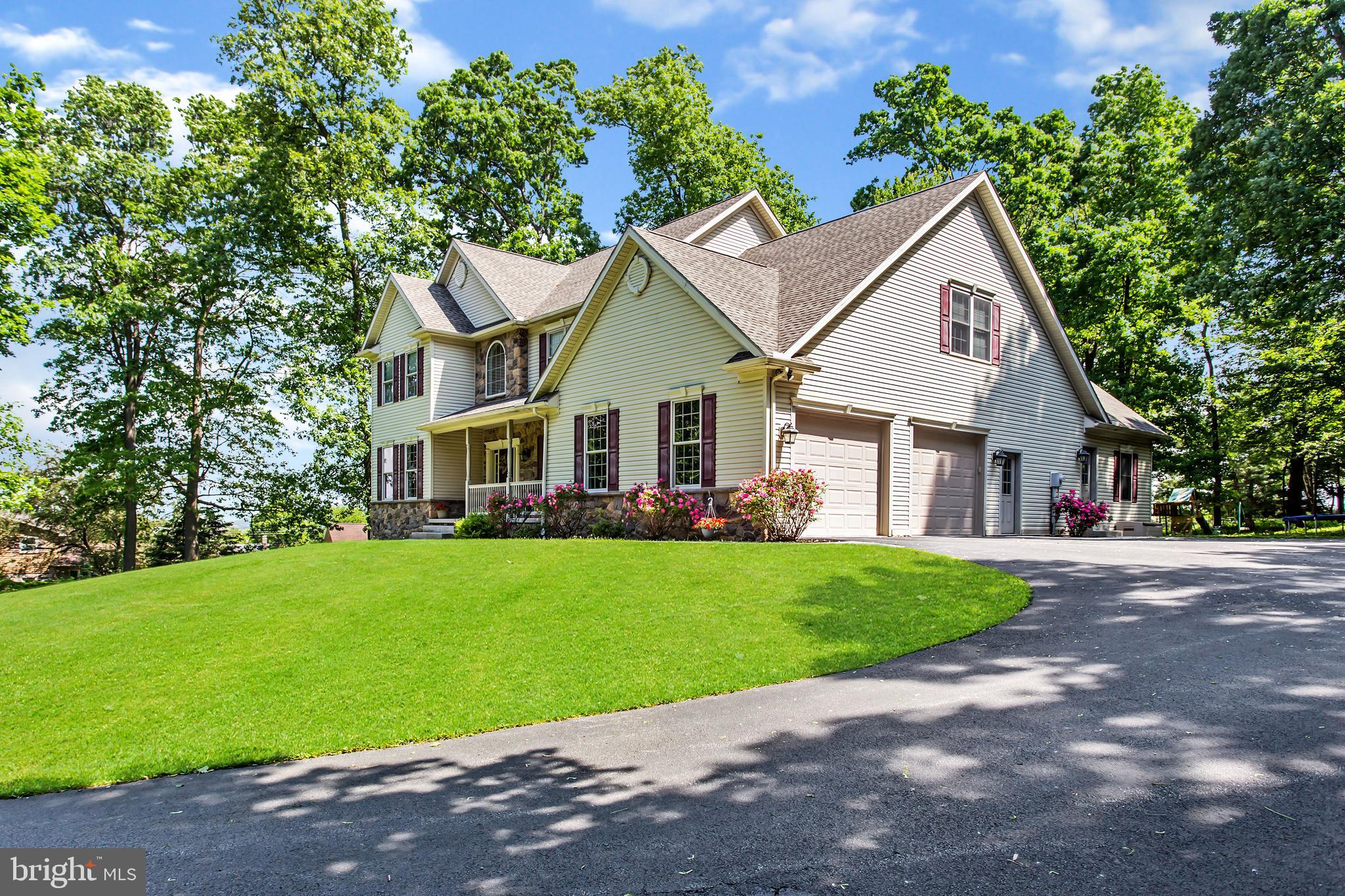 216 Blooming Grove Road Hanover, PA 17331 - Photo 5 of 60 a front view of a house with a garden and yard