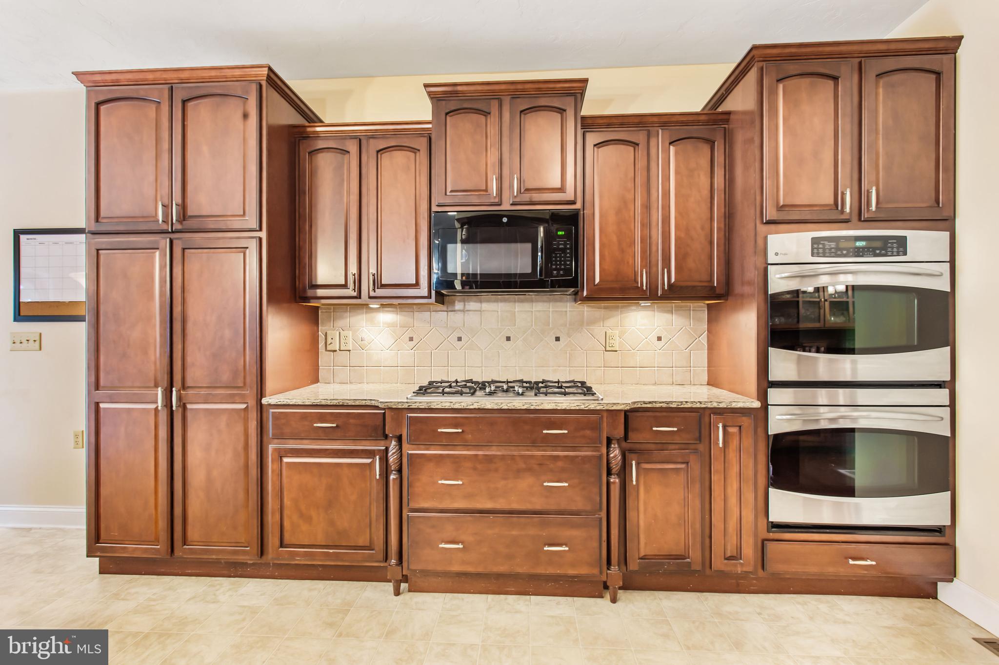 216 Blooming Grove Road Hanover, PA 17331 - Photo 7 of 60 a kitchen with granite countertop a refrigerator stove and microwave