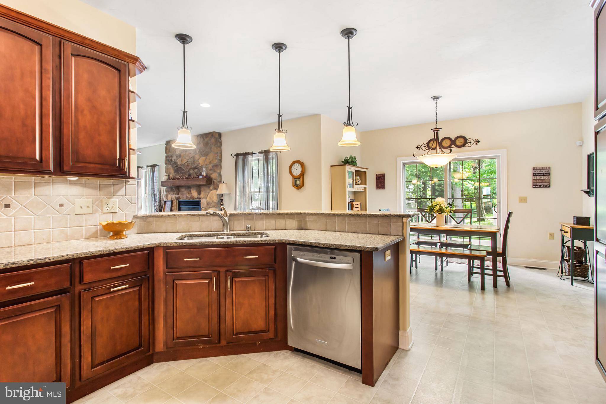 216 Blooming Grove Road Hanover, PA 17331 - Photo 8 of 60 a kitchen with kitchen island granite countertop a table chairs and a wooden floor