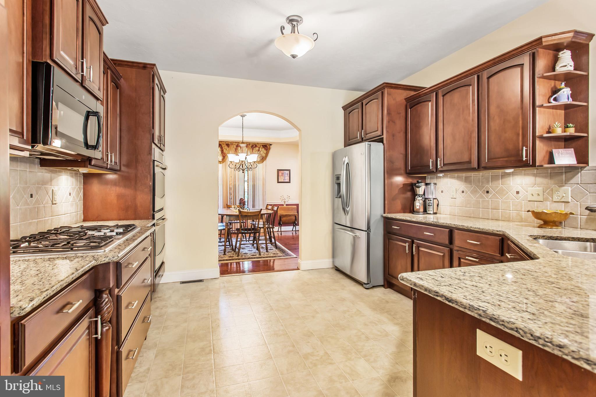 216 Blooming Grove Road Hanover, PA 17331 - Photo 9 of 60 a kitchen with stainless steel appliances granite countertop a stove top oven a refrigerator a sink and dishwasher