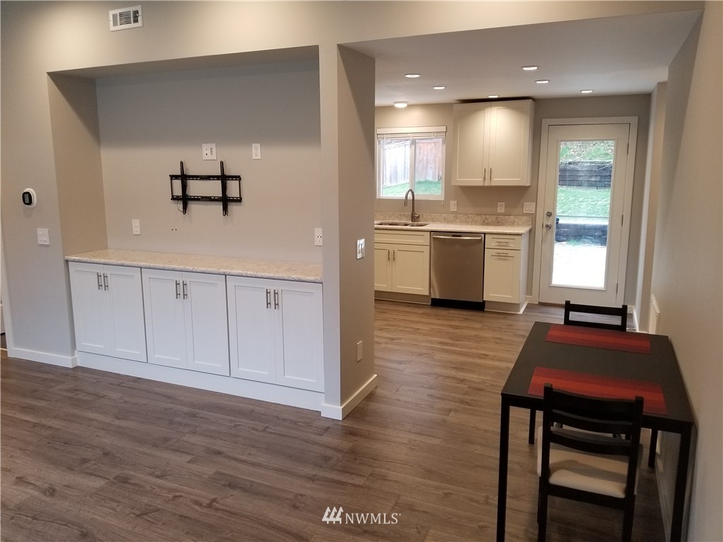 3436 Southeast 5th Street Renton, WA 98058 - Photo 2 of 28 a kitchen with white cabinets and sink