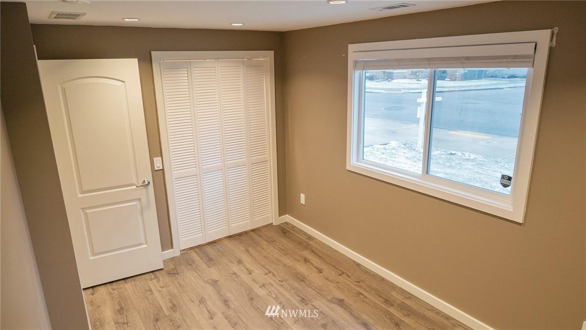 3436 Southeast 5th Street Renton, WA 98058 - Photo 14 of 28 an empty room with wooden floor and a window