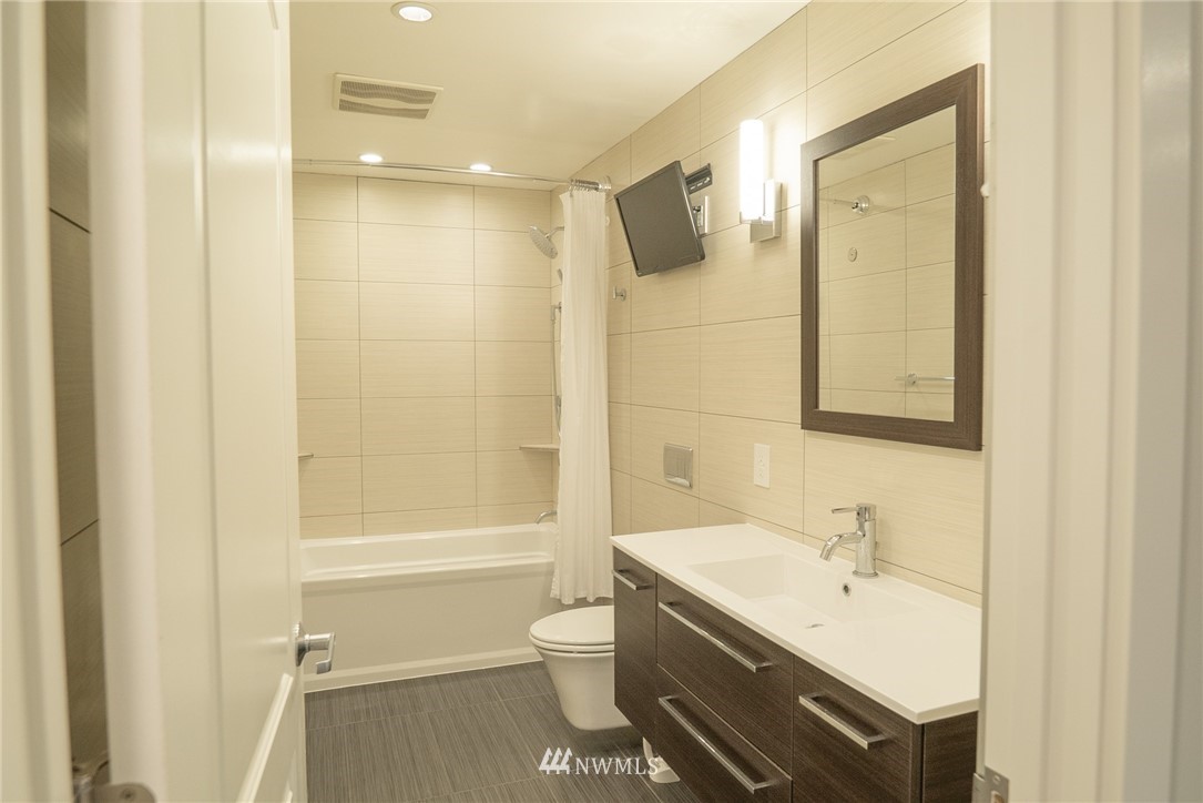 3436 Southeast 5th Street Renton, WA 98058 - Photo 16 of 28 a bathroom with a bathtub shower sink vanity and toilet