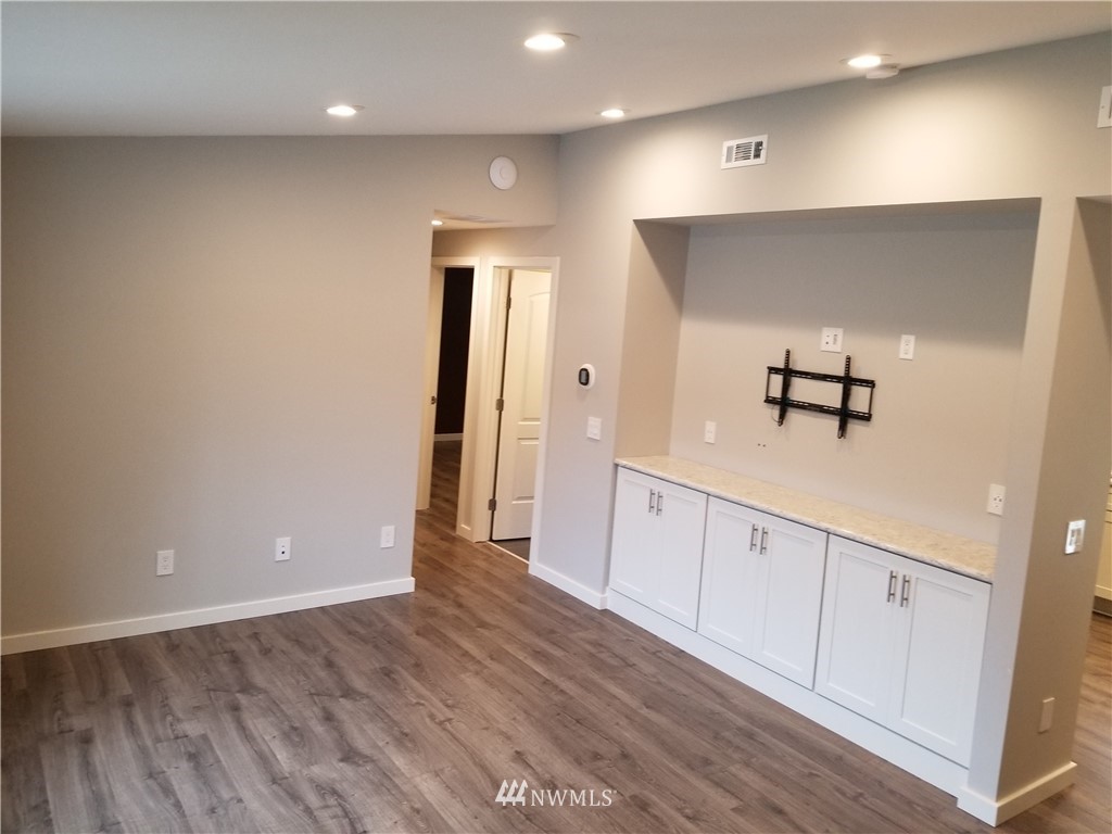 3436 Southeast 5th Street Renton, WA 98058 - Photo 3 of 28 a view of a hallway with wooden floor