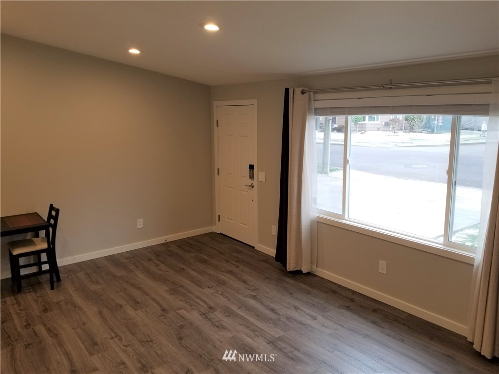 3436 Southeast 5th Street Renton, WA 98058 - Photo 5 of 28 a view of an empty room with wooden floor and a window