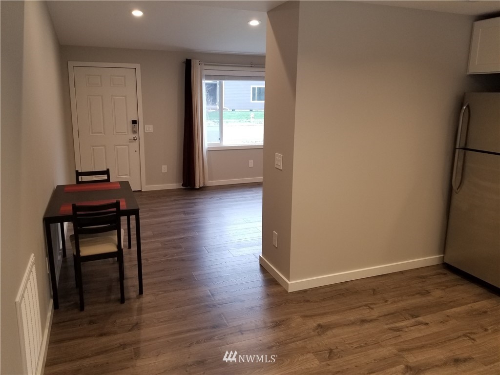 3436 Southeast 5th Street Renton, WA 98058 - Photo 8 of 28 an empty room with wooden floor and windows