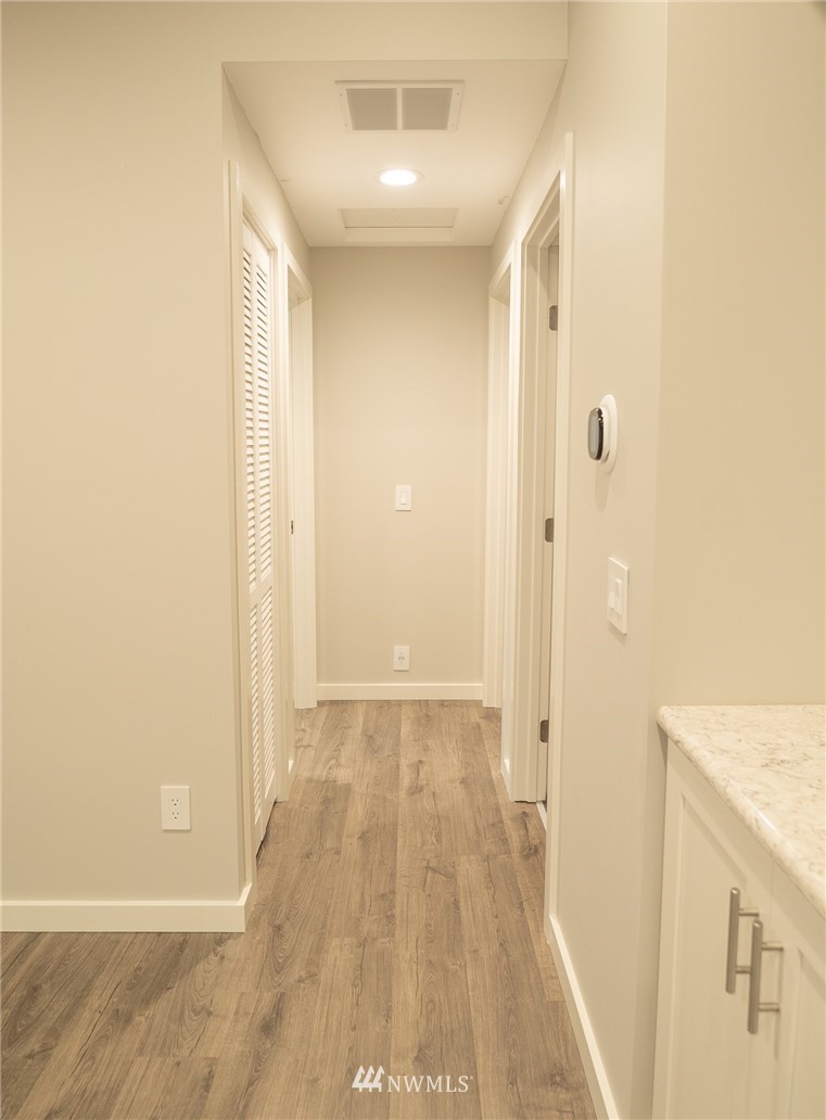 3436 Southeast 5th Street Renton, WA 98058 - Photo 9 of 28 a view of a hallway with wooden floor