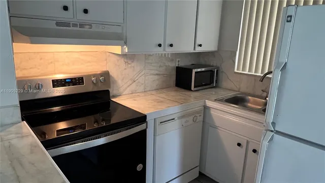 a kitchen with a stove and a microwave