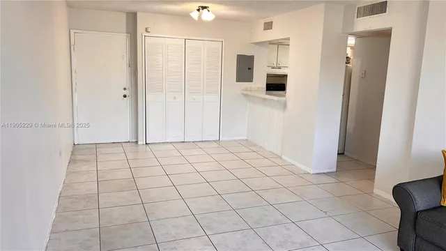 a view of a livingroom with an empty space and a window
