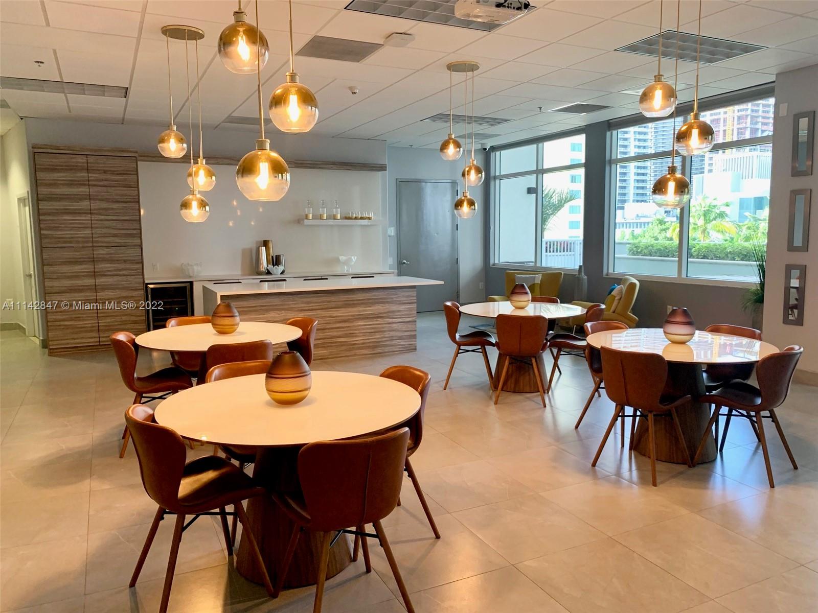 1200 Brickell Bay Drive, Unit 1812 Miami, FL 33131 - Photo 11 of 24 a outdoor dining space with furniture and window