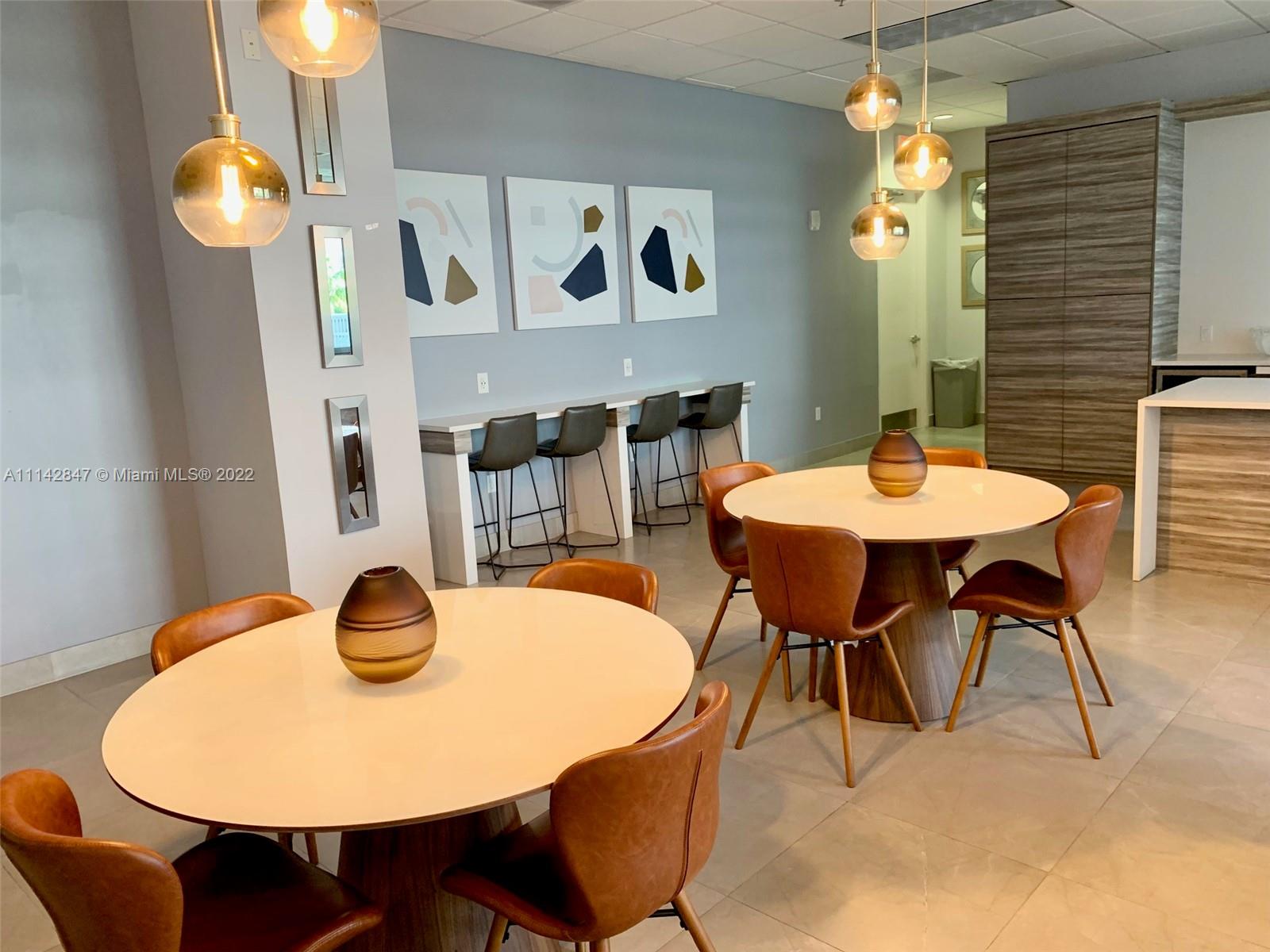 1200 Brickell Bay Drive, Unit 1812 Miami, FL 33131 - Photo 13 of 24 a view of a dining room with furniture and wooden floor