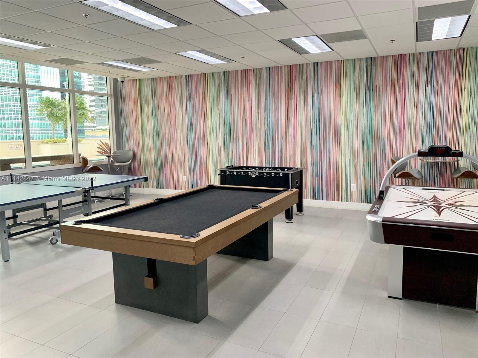 1200 Brickell Bay Drive, Unit 1812 Miami, FL 33131 - Photo 14 of 24 a room with pool table and windows