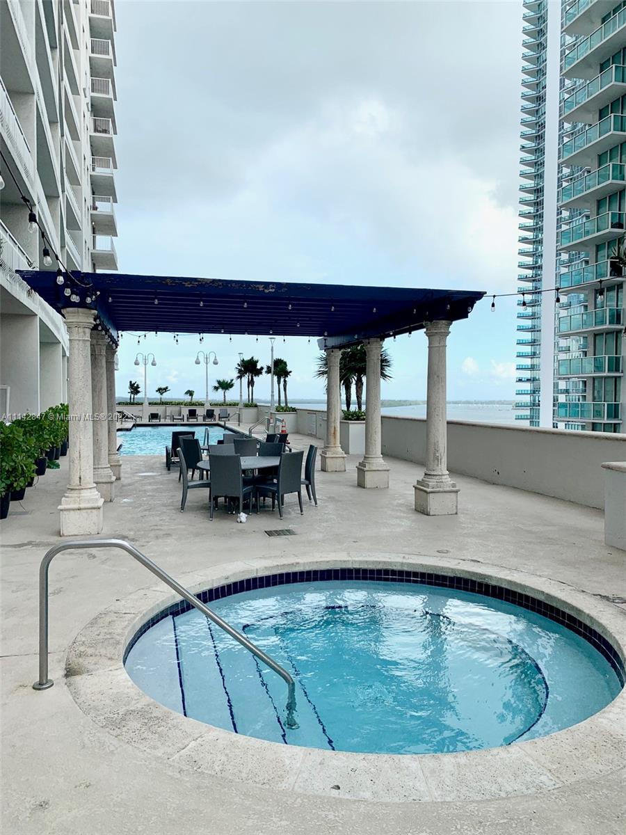 1200 Brickell Bay Drive, Unit 1812 Miami, FL 33131 - Photo 16 of 24 a view of a swimming pool with outdoor seating