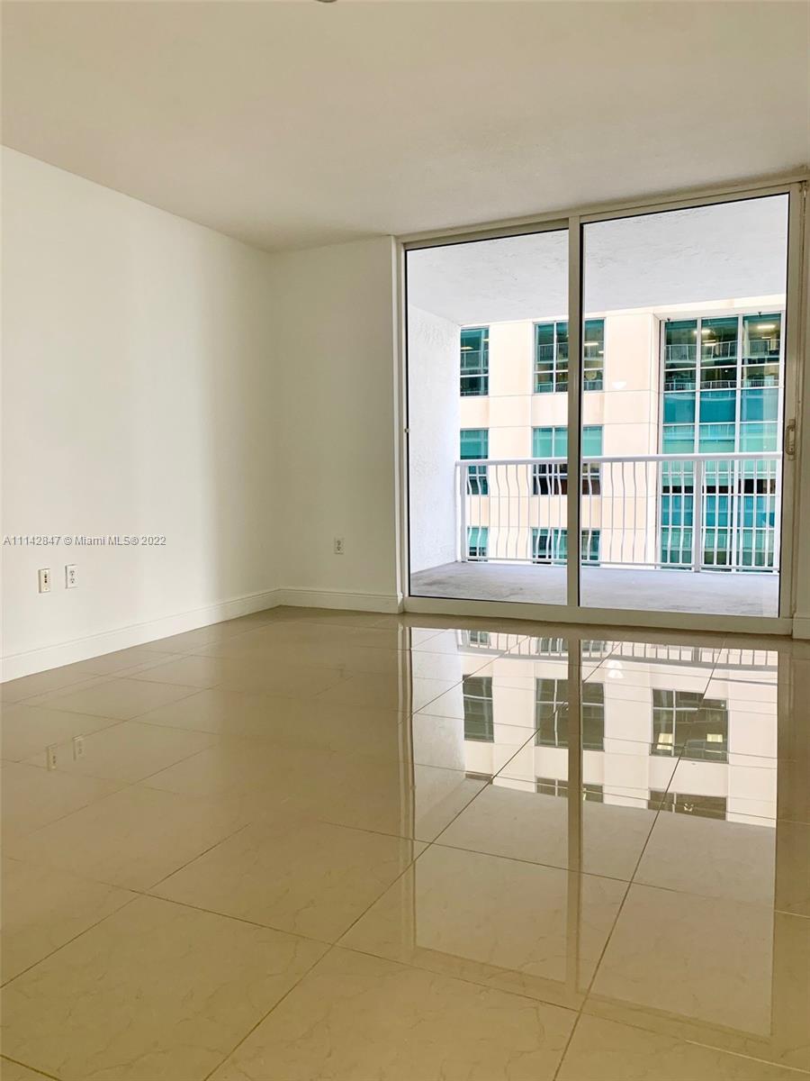 1200 Brickell Bay Drive, Unit 1812 Miami, FL 33131 - Photo 5 of 24 a room with a large window