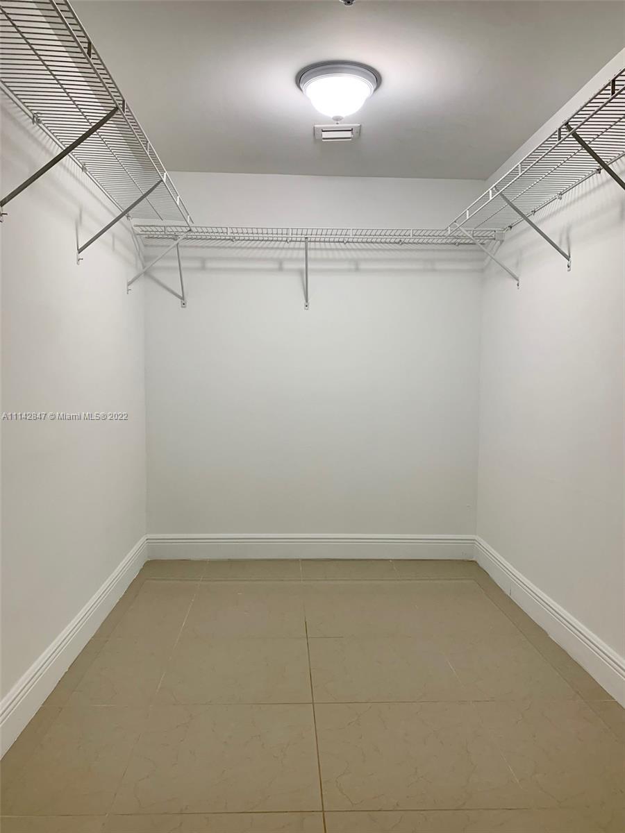 1200 Brickell Bay Drive, Unit 1812 Miami, FL 33131 - Photo 6 of 24 a view of a room with racks on the wall