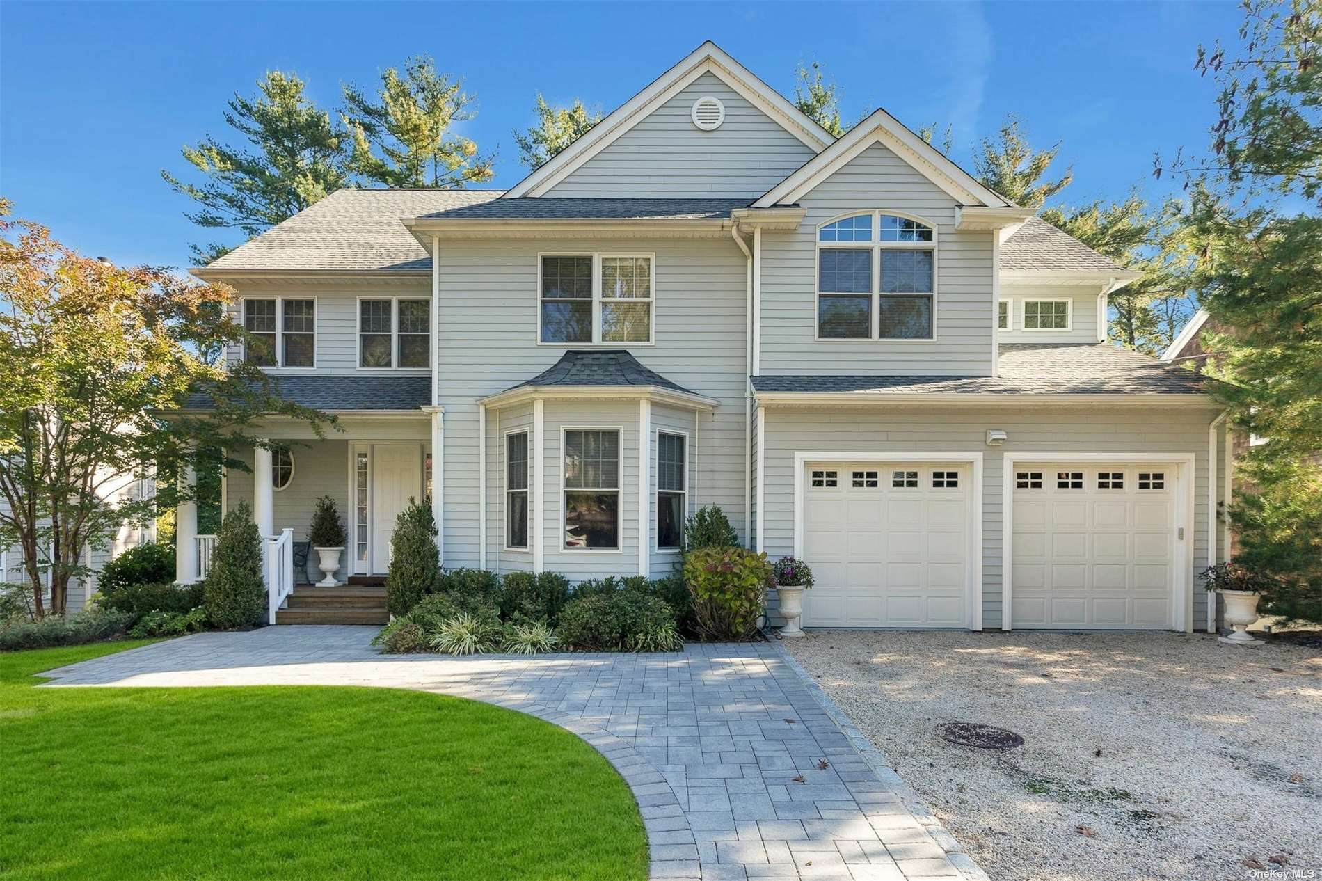 900 Harborview Road Mill Neck, NY 11765 - Photo 1 of 1 a front view of a house with a yard and garage