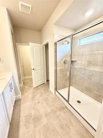 en empty room with windows and fan