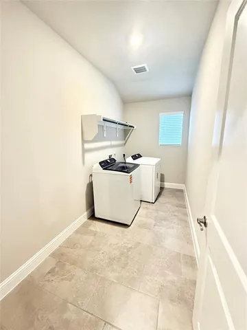 a bed room with a bed and a chair