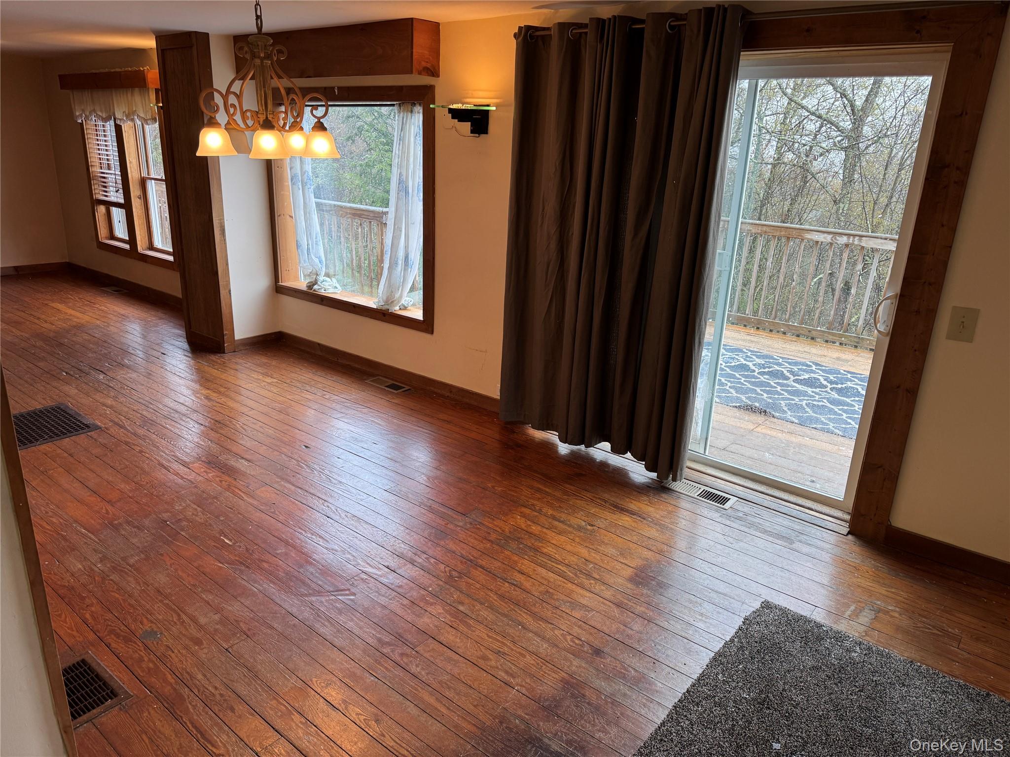 96 White Roe Lake Road Livingston Manor, NY 12758 - Photo 12 of 34 an empty room with wooden floor and windows