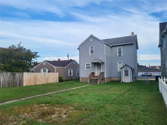a front view of house with yard and green space