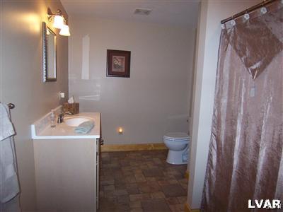8756 South Loop Road Slatington, PA 18080 - Photo 22 of 25 LGE 1ST FLR BATH W/LAMINATE FLOORING