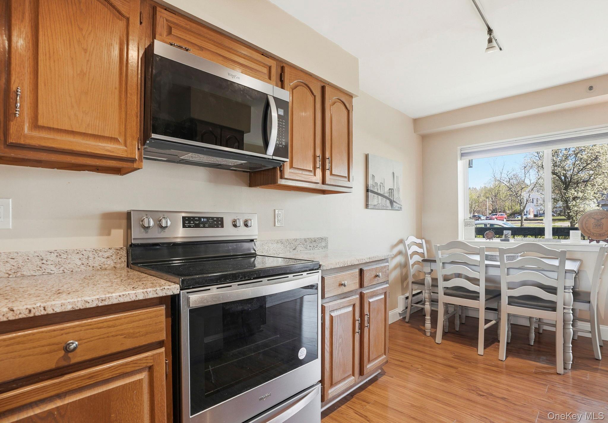 4 Marina Drive, Unit D2 Mahopac, NY 10541 - Photo 11 of 39 The kitchen features wood cabinetry, granite countertops, and stainless steel appliances, including a microwave and range