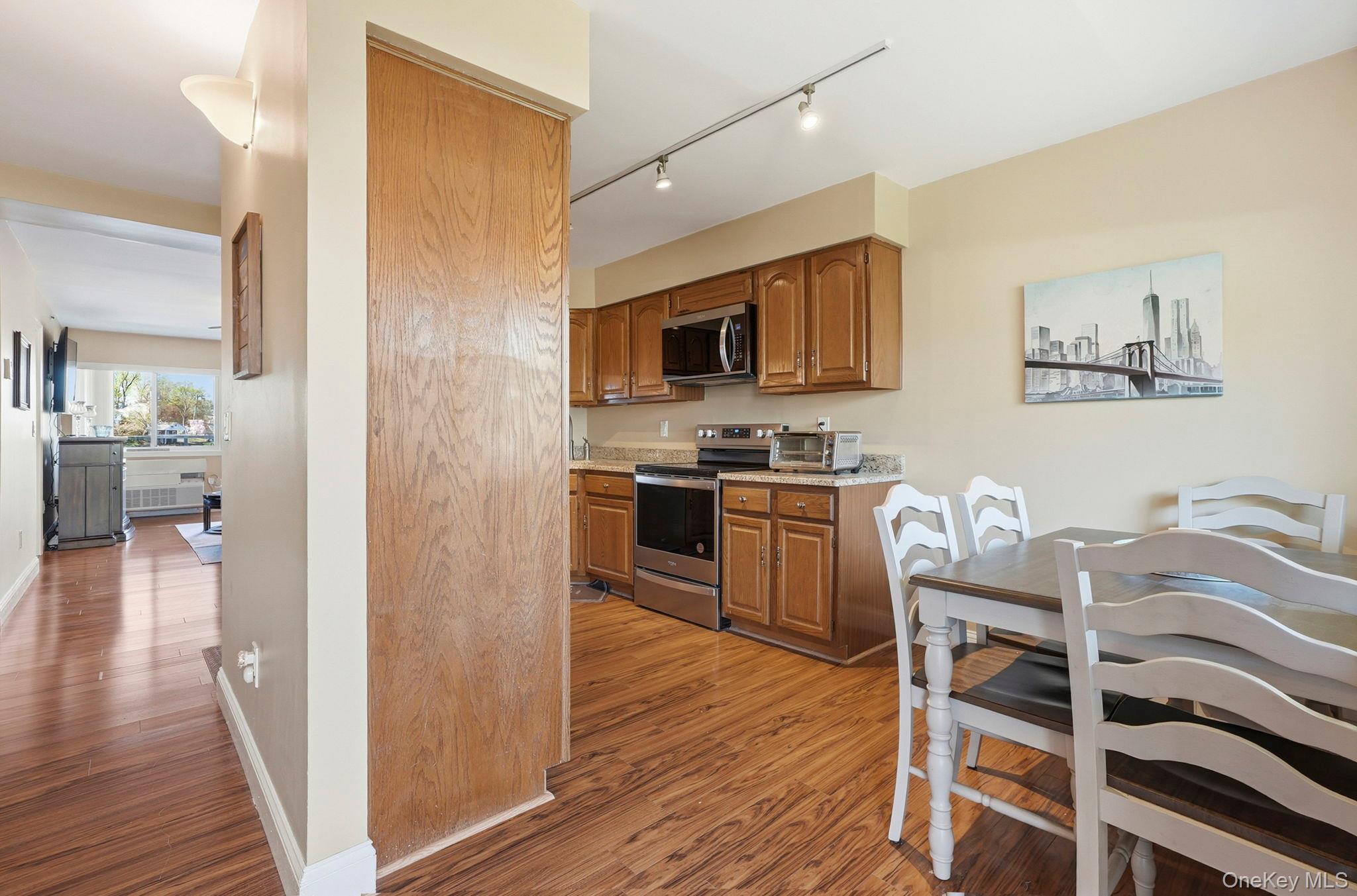 4 Marina Drive, Unit D2 Mahopac, NY 10541 - Photo 12 of 39 The kitchen features wood cabinetry, stainless steel appliances, and track lighting
