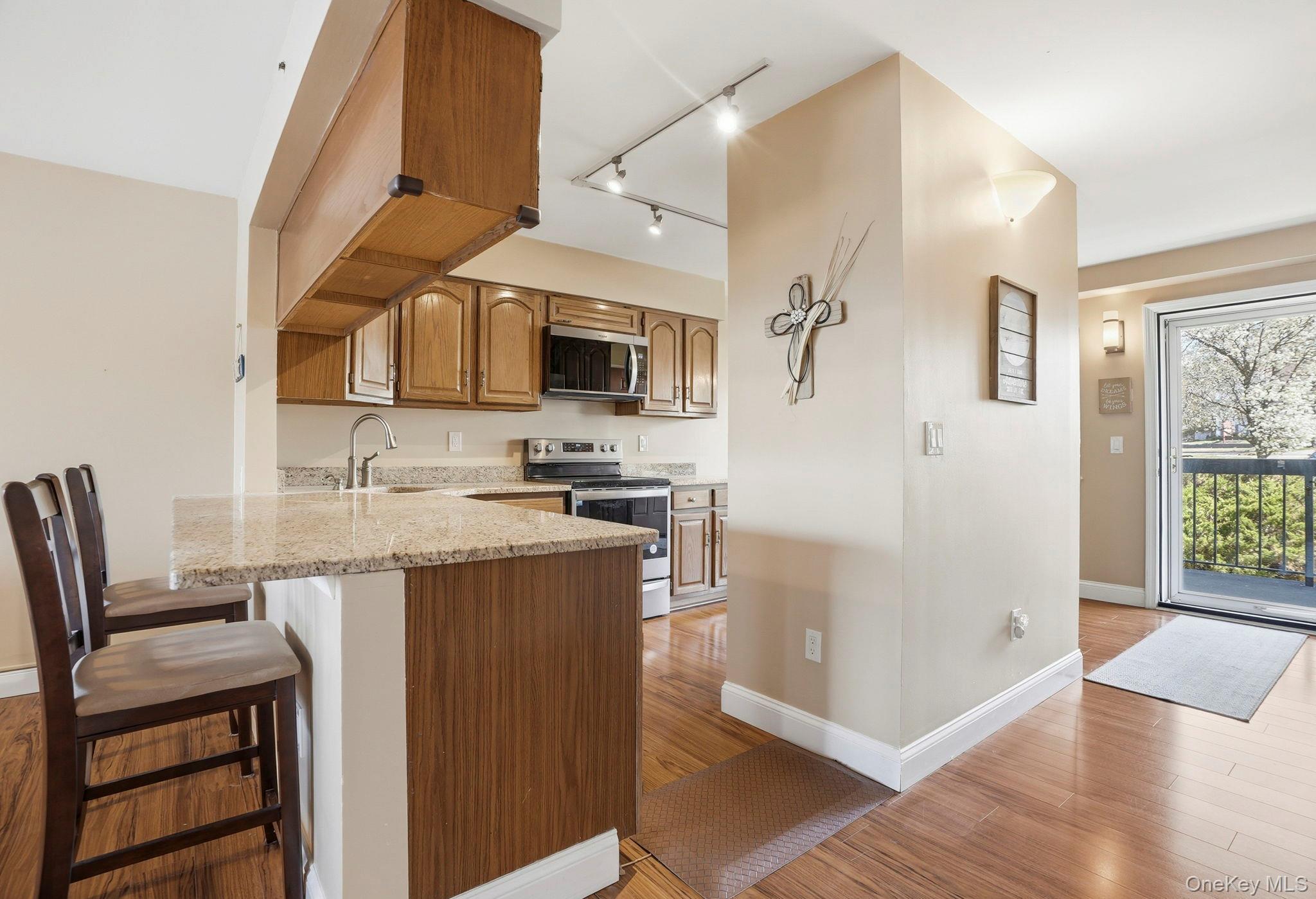 4 Marina Drive, Unit D2 Mahopac, NY 10541 - Photo 15 of 39 The kitchen features wood cabinetry, a granite countertop, and stainless steel appliances