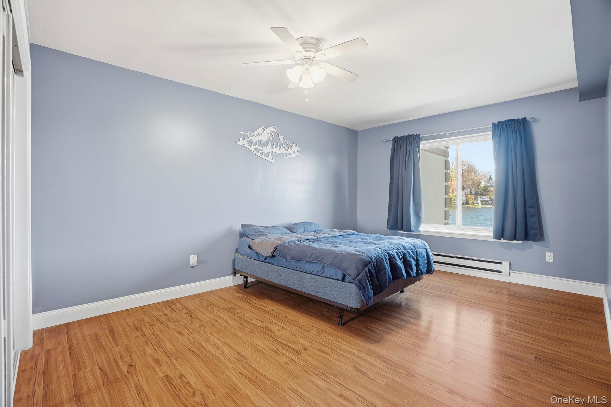 4 Marina Drive, Unit D2 Mahopac, NY 10541 - Photo 17 of 39 This room features wood flooring, light blue walls, and a window with a water view