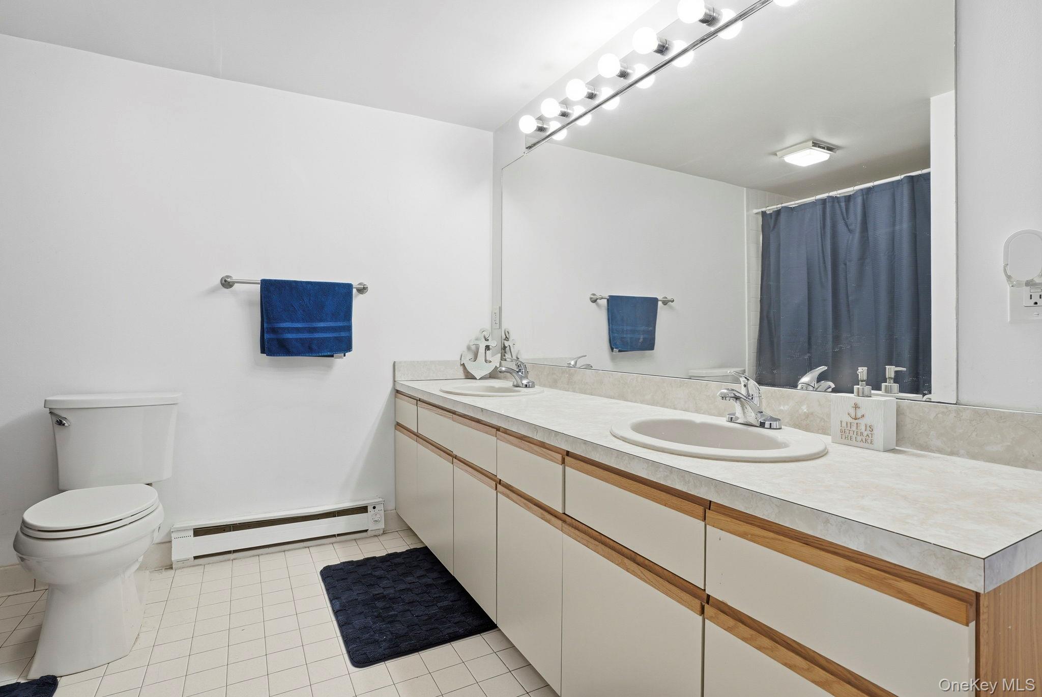4 Marina Drive, Unit D2 Mahopac, NY 10541 - Photo 19 of 39 The bathroom features a dual sink vanity with ample countertop space and a large mirror with overhead lighting