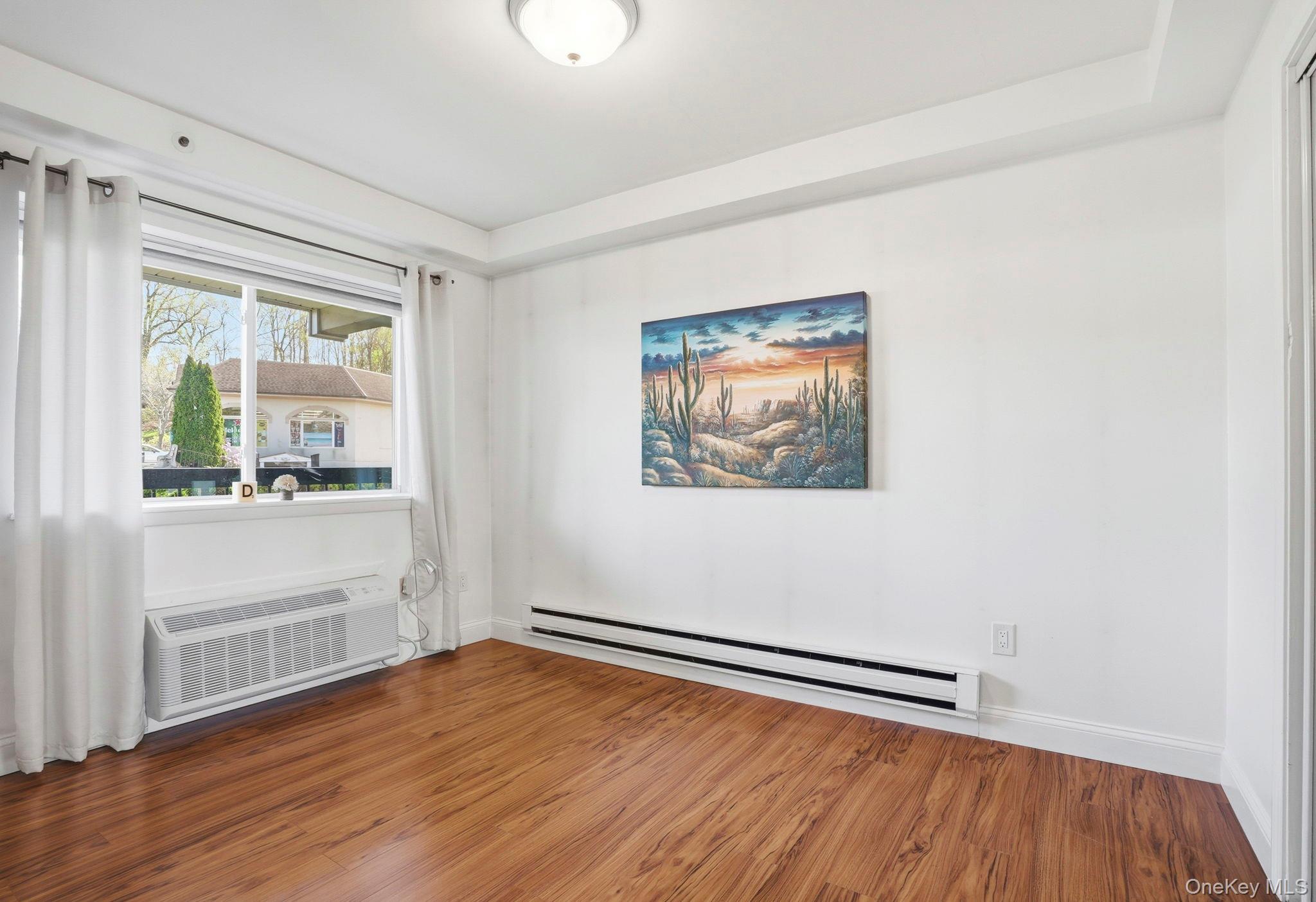 4 Marina Drive, Unit D2 Mahopac, NY 10541 - Photo 22 of 39 This room features warm-toned flooring, white walls, and a window providing natural light