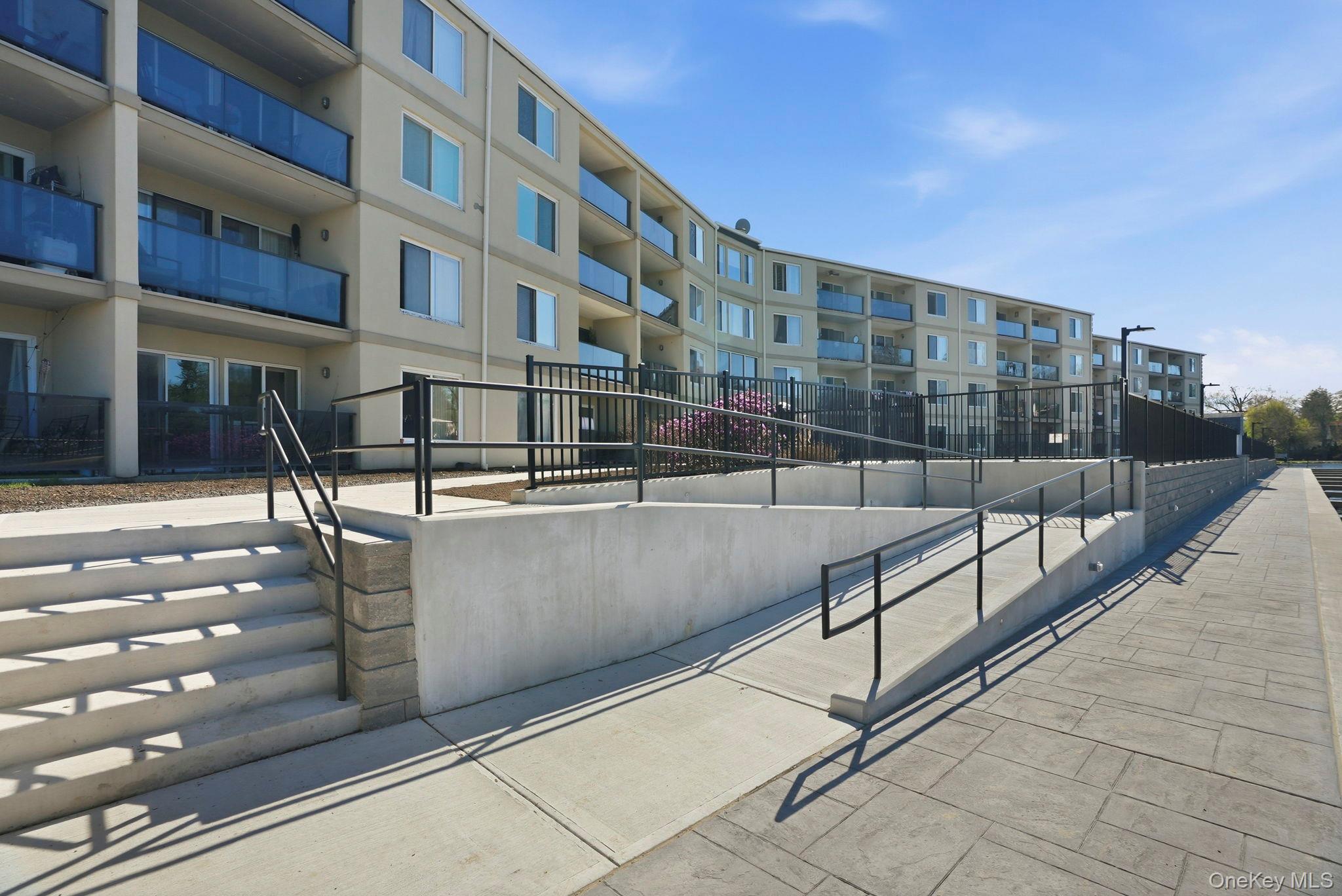 4 Marina Drive, Unit D2 Mahopac, NY 10541 - Photo 29 of 39 The property features a multi-story building with balconies, visible from a paved outdoor area