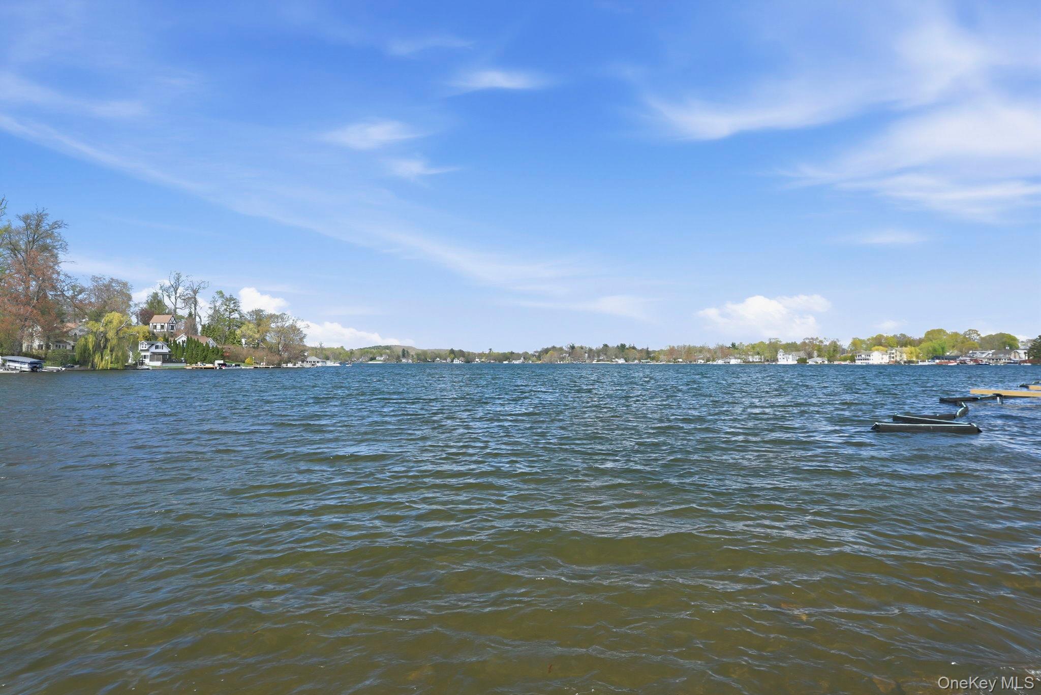 4 Marina Drive, Unit D2 Mahopac, NY 10541 - Photo 33 of 39 Expansive waterfront view featuring a wide body of water and a distant shoreline with visible properties and lush trees