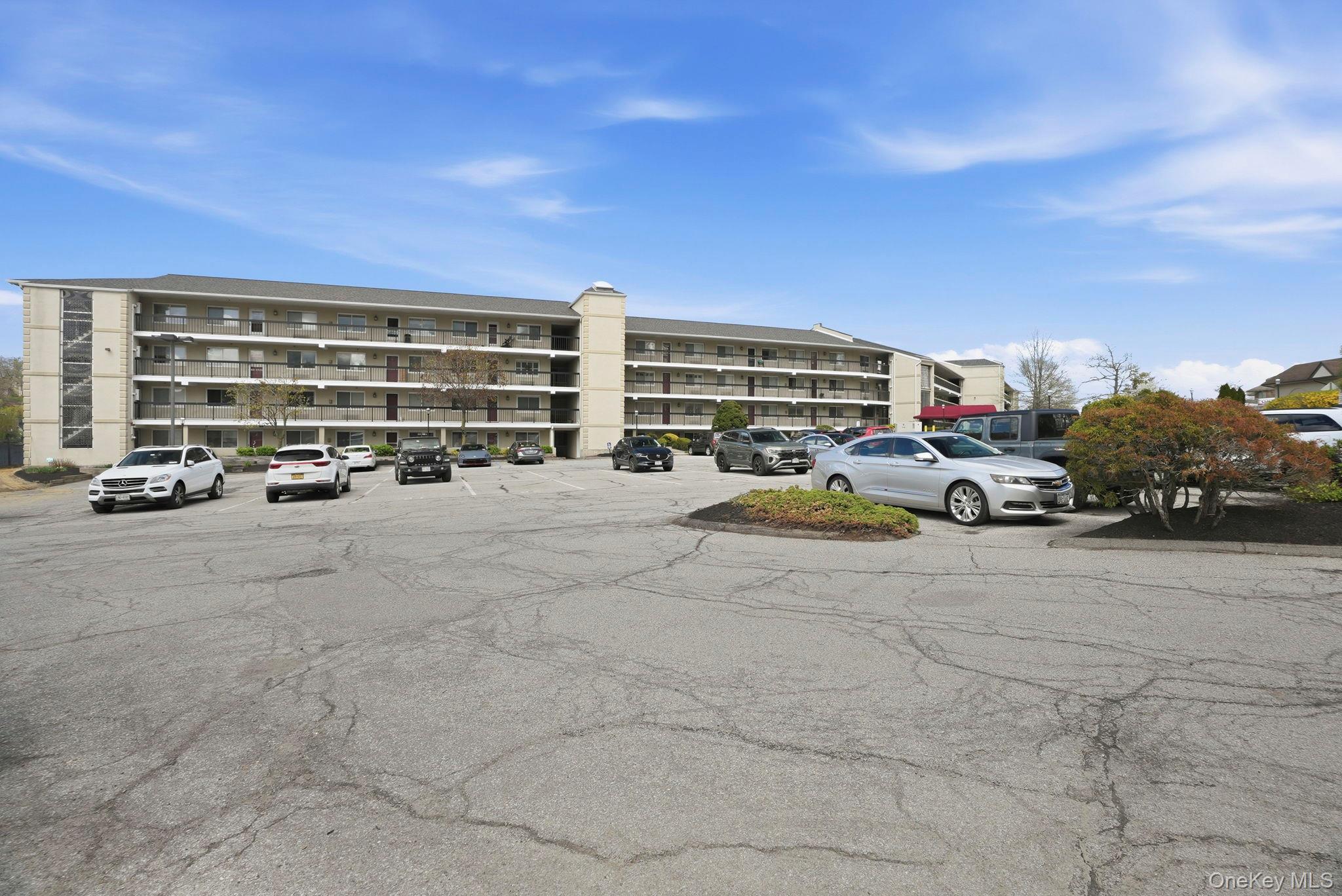 4 Marina Drive, Unit D2 Mahopac, NY 10541 - Photo 4 of 39 The property features a multi-story building with balconies and an expansive parking area